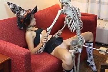 A skeleton with a rubber dick fucks a cute witch