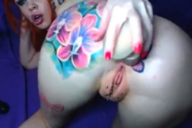 Informal woman with pierced pussy and tattoos jerks off on camera